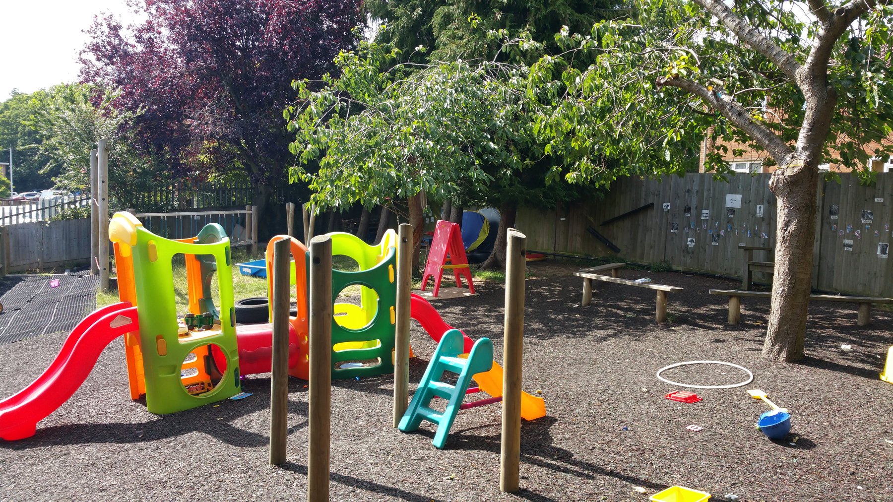 Nursery outdoor play area with slide and climbing frame